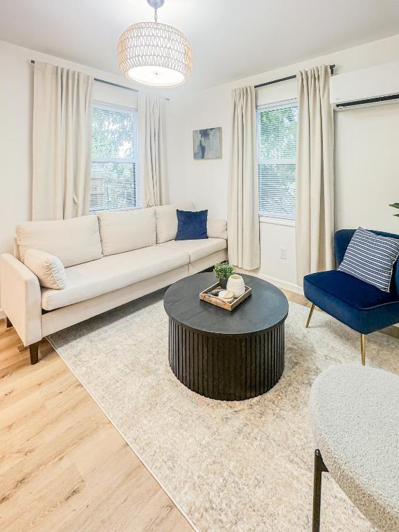 a living room with a couch and a table at 1 BR Fire Pit BBQ Retreat in Evansville