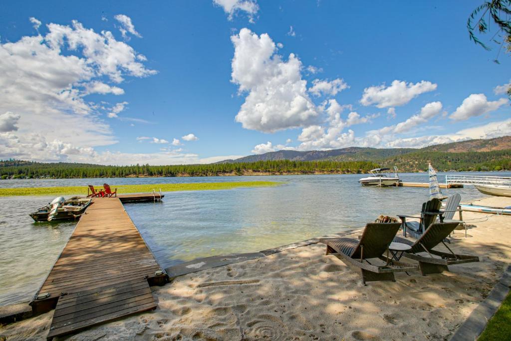 a dock with chairs and boats on a lake at Riverfront Duplex Dock and Views in Nine Mile Falls in Nine Mile Falls