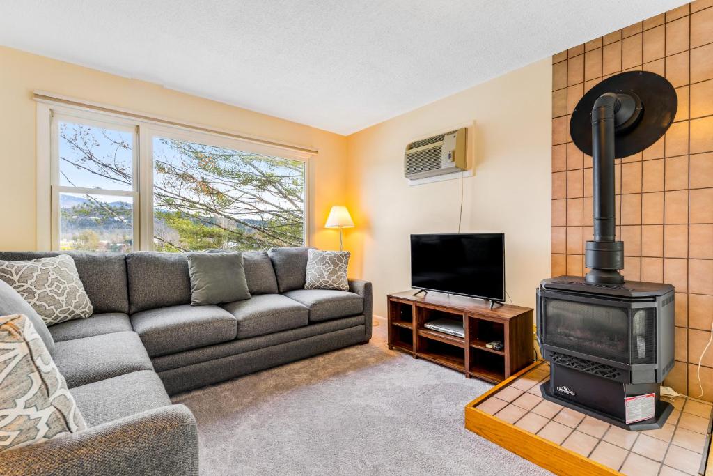 a living room with a couch and a stove at Mountainside Resort F303 in Stowe