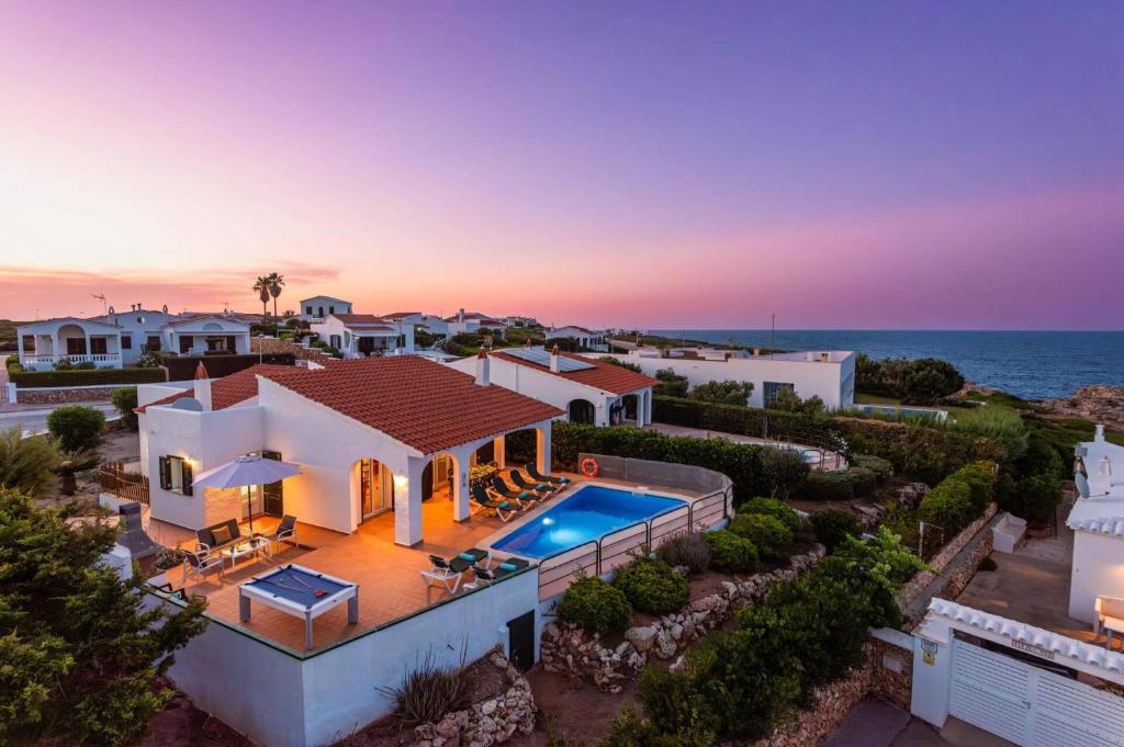 an aerial view of a house with a swimming pool at Villa Blanc Arenal by Villa Plus in Es Mercadal
