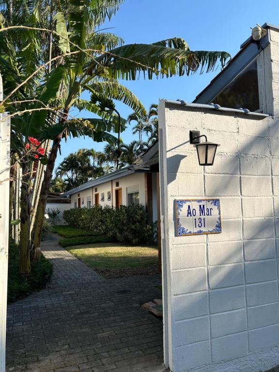 a no man sign on a white garage door at Ao Mar - Hospedagem in São Sebastião