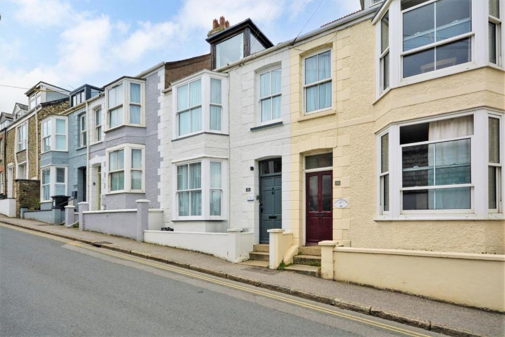 a row of houses on the side of a street at 12 New Street in Padstow