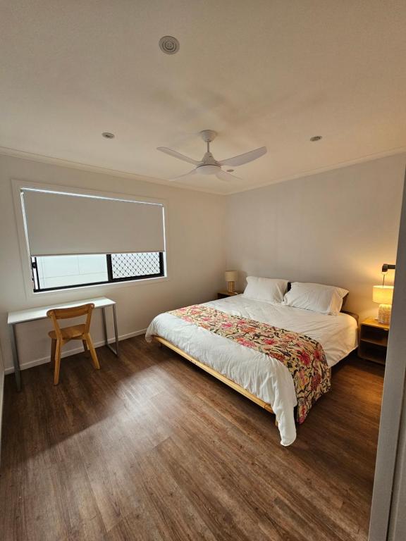 a bedroom with a bed and a desk and a window at Self-Contained 2BR Guest Suite with On-site Parking in Rochedale South