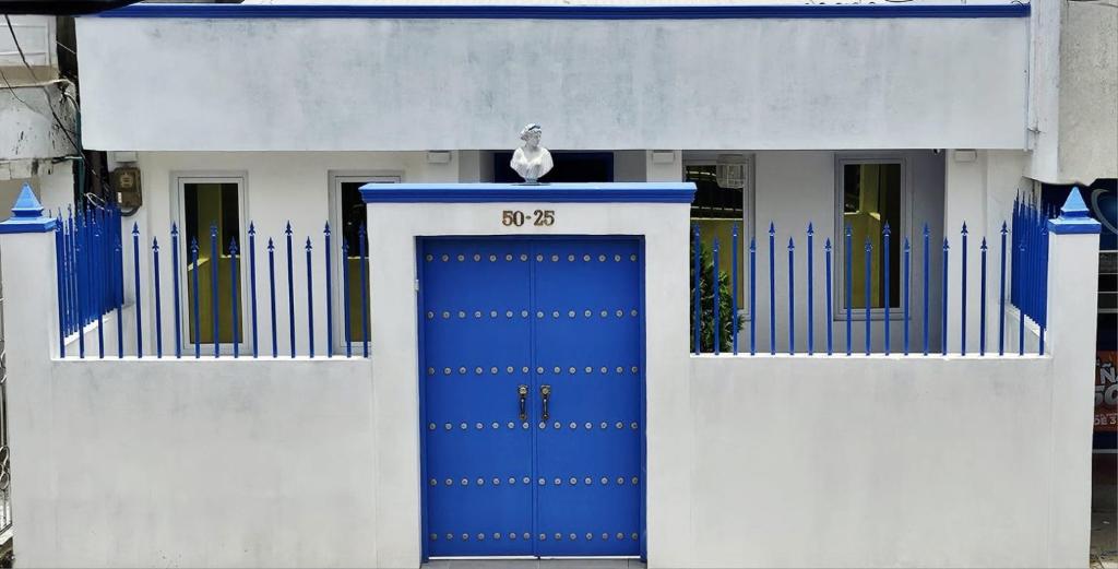 a blue door with a bird sitting on top of it at La Contessa in Cartagena de Indias
