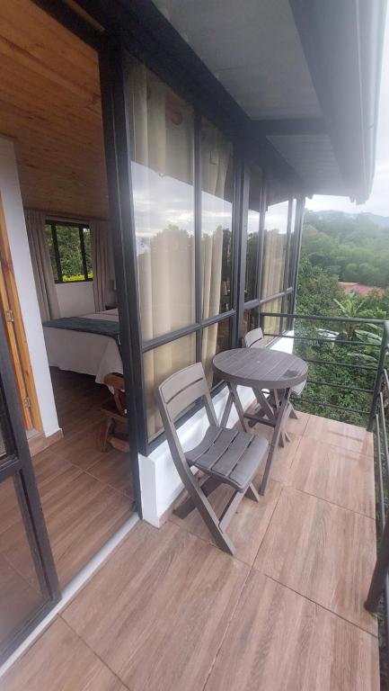 a room with a table and a chair on a balcony at Alojamiento natural rural LOS NOGALES, apartamentos tipo glamping, avistamiento de aves, paisaje cafetero in San Francisco