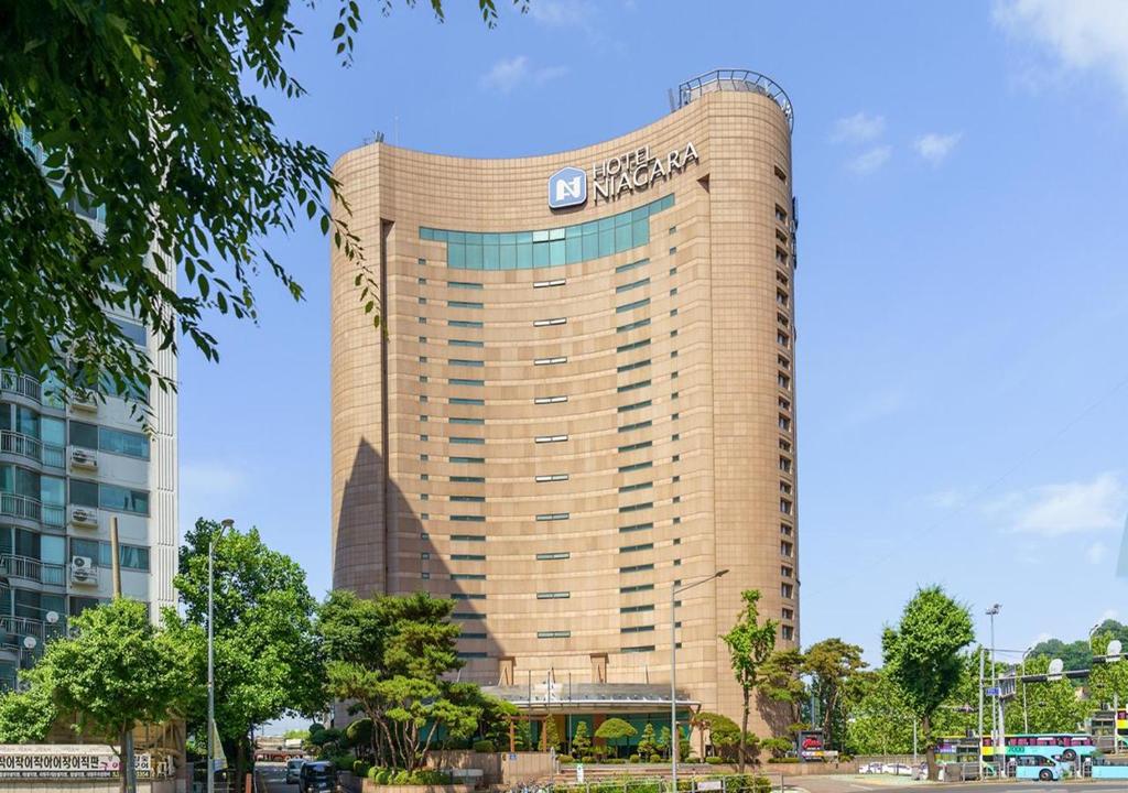 a tall building with a sign on it at Niagara Hotel in Seoul