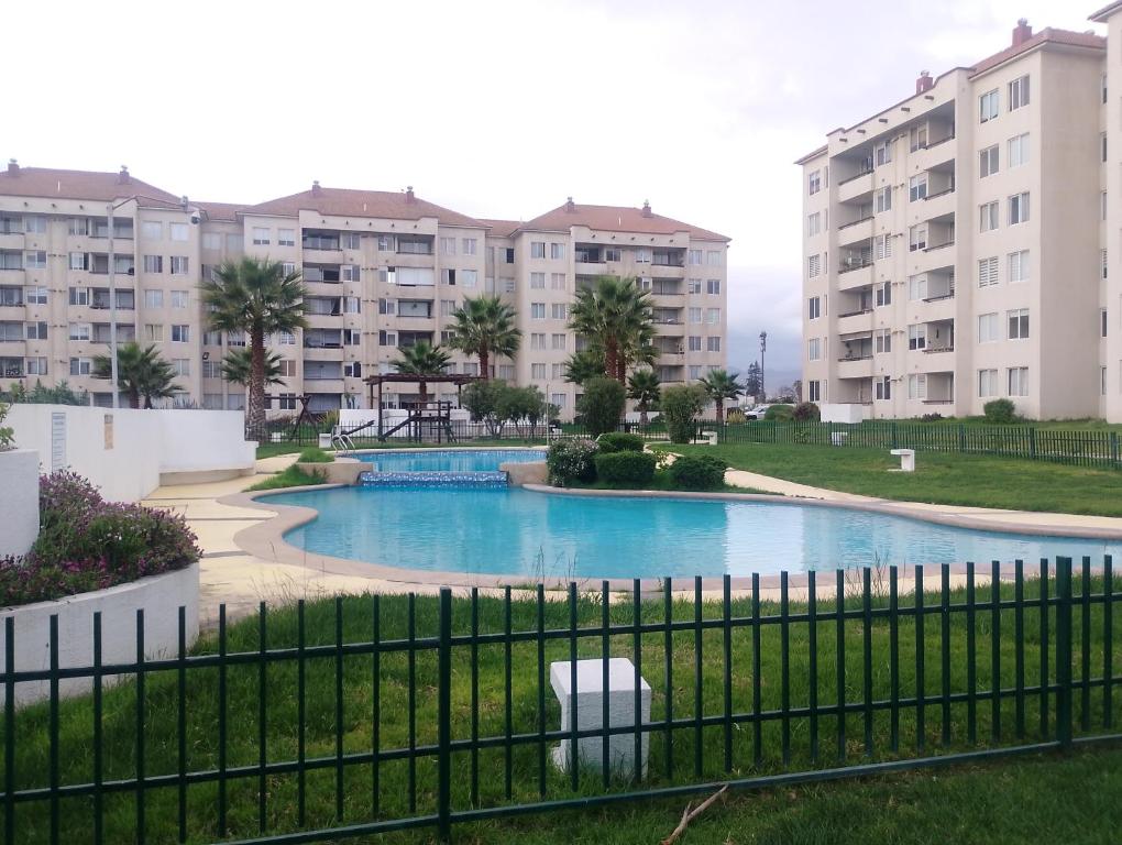 a view of an apartment complex from a fence at Moderno y cómodo departamento a pasos de la playa in La Serena