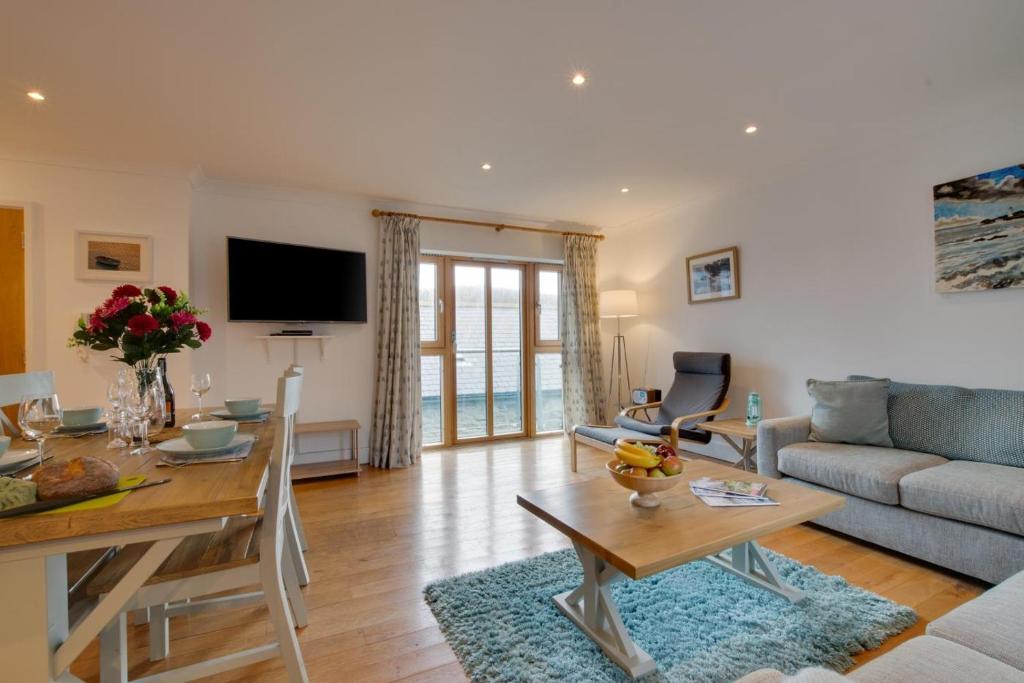 a living room with a couch and a table at Seahorse Apartment in Porthleven