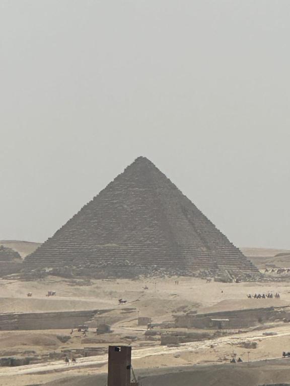 a view of the pyramid ofaraohs in the desert at king pyramids in Cairo
