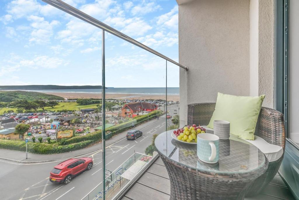 a balcony with a table and a view of a road at Tidal Reach - W8 in Woolacombe
