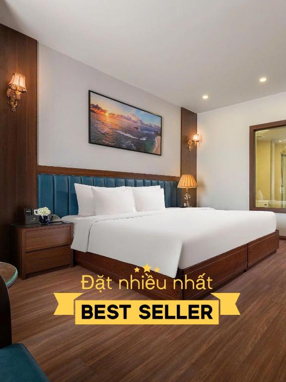 a bedroom with a large white bed with a yellow sign at Halong Boutique Hotel in Ha Long