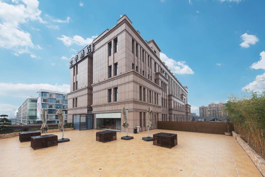 a large building with benches in front of it at JI Hotel Hangzhou Alibaba Xixi Park in Hangzhou