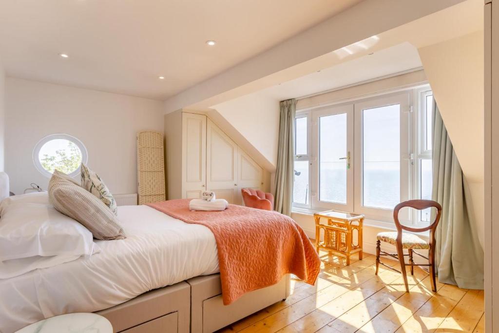 a bedroom with a bed and a large window at Sea Vista - Dovercourt in Harwich