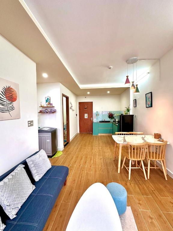 a living room with a blue couch and a table at An's House In Phan Rang in Kinh Dinh