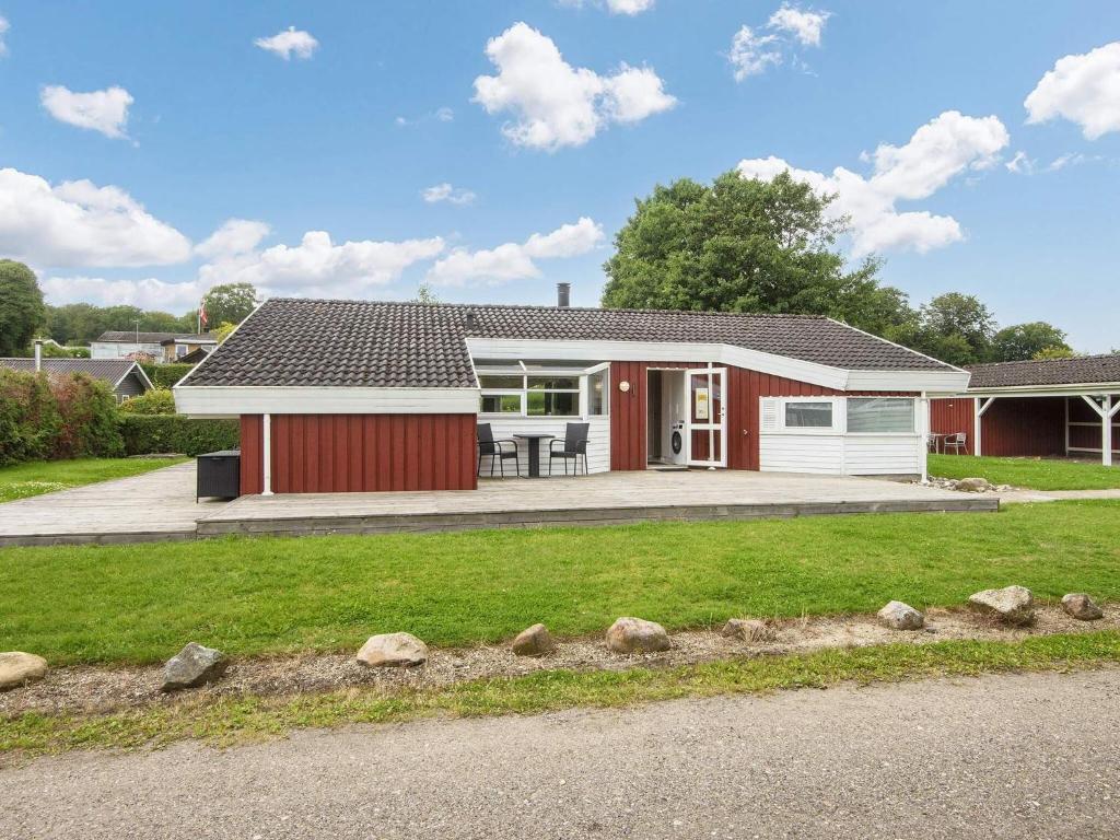 a home with a red and white house at 6 person holiday home in Bjert-By Traum in Binderup Strand
