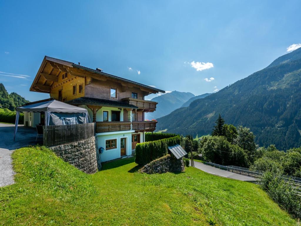 a house on a hill with mountains in the background at Chalet in Wald near Zillertal Ski Area in Wald im Pinzgau