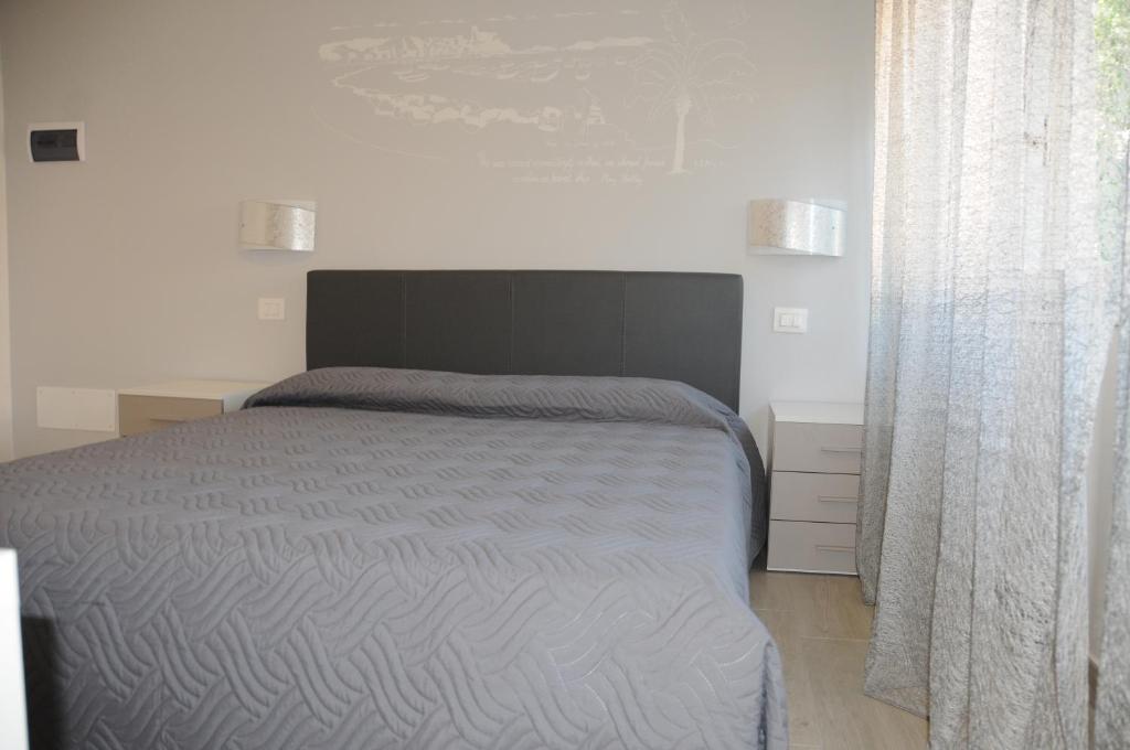 A bed or beds in a room at Affittacamere La Perla