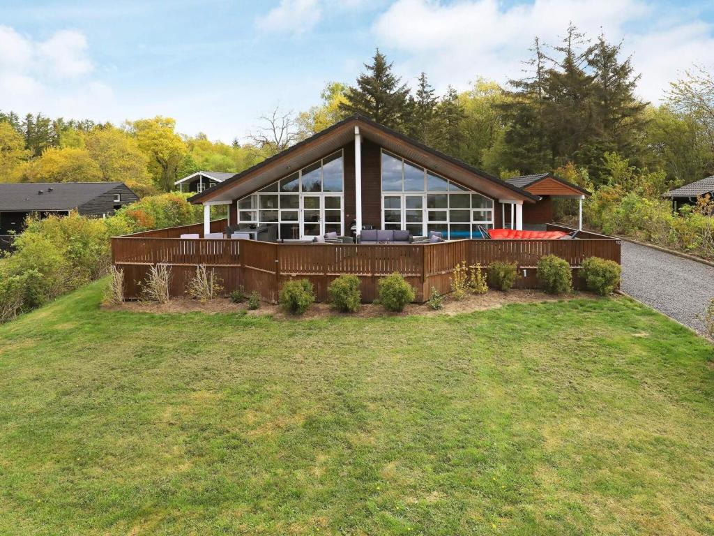a large house on top of a grass field at 4 star holiday home in Skals in Skals