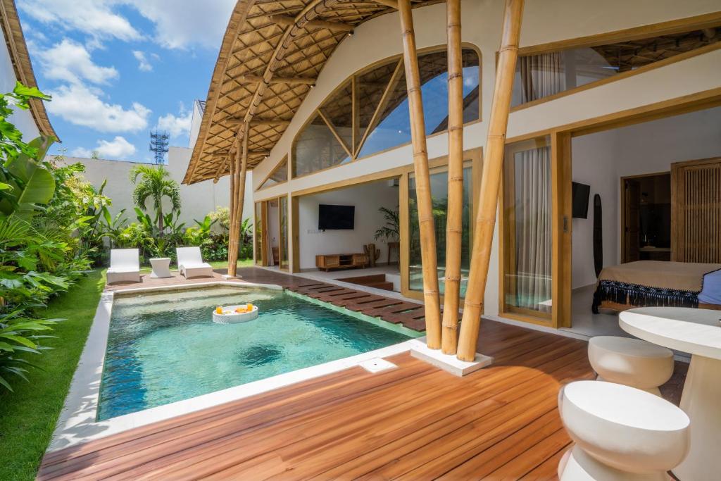 a villa with a swimming pool and a house at M&M Dream Villa - 2 BR Villa in Kerobokan in Kerobokan