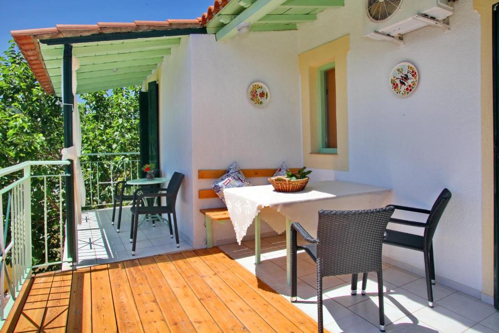 a patio with a table and chairs on a deck at Pelagos in Stafylos