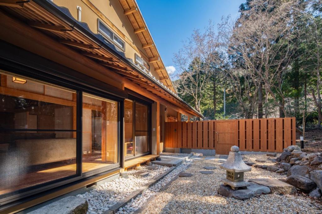 a house with sliding glass doors and a fire hydrant at Miyabi Sengokuhara Hot Spring Villa - Vacation STAY 60344v in Sengokuhara