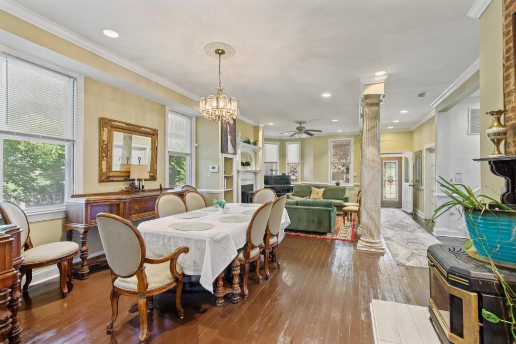 a dining room and living room with a table and chairs at Charming Victorian Home with Porch & Large Yard home in Catonsville