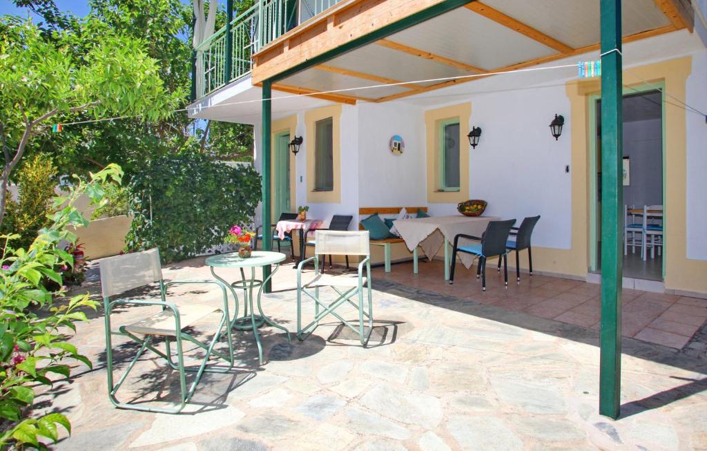 a patio with chairs and a table and a table and chairs at Pelagos in Stafylos
