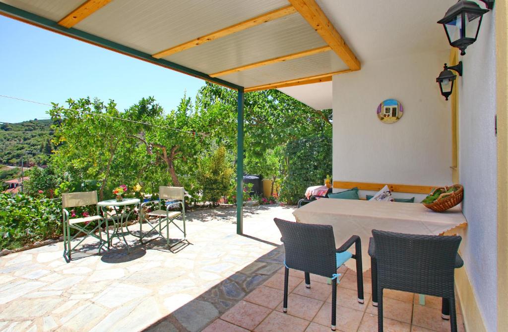 a patio with a table and chairs on a patio at Pelagos in Stafylos