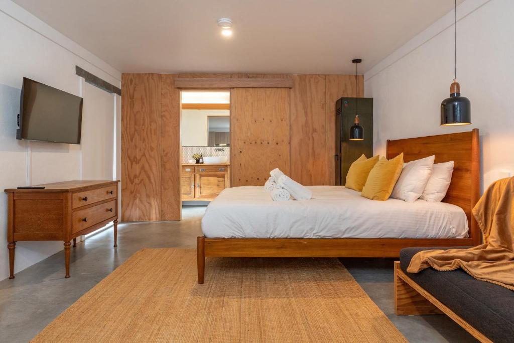 a bedroom with a bed and a tv and a couch at Nordhaus Studio in Smiths Lake