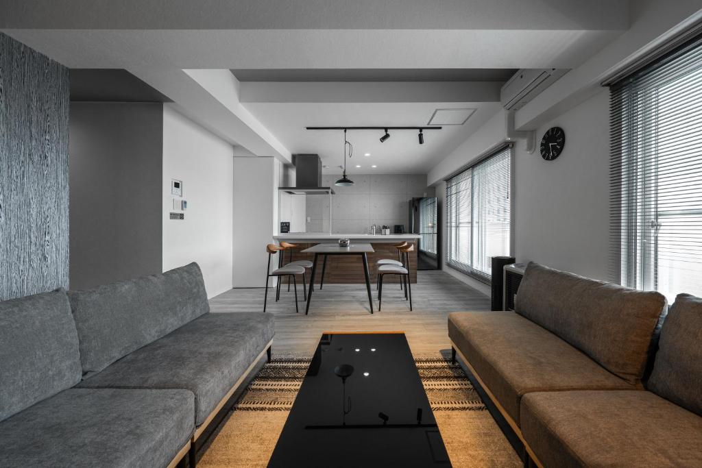 a living room with a couch and a table at Luxia 601 in Sapporo