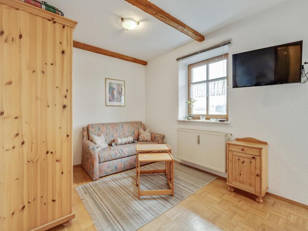 a living room with a couch and a flat screen tv at Wohnung in Lohberg nahe Arber Skipisten in Schwarzenbach