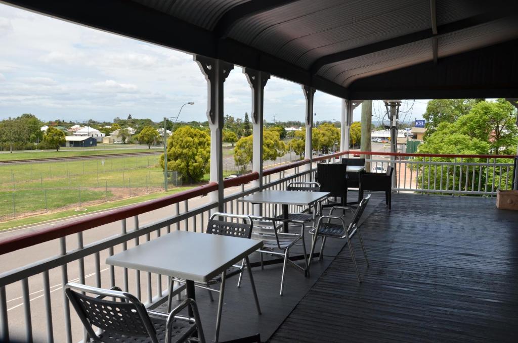 a cafeteria with tables and chairs on a balcony at Royal Gatton Hotel in Gatton