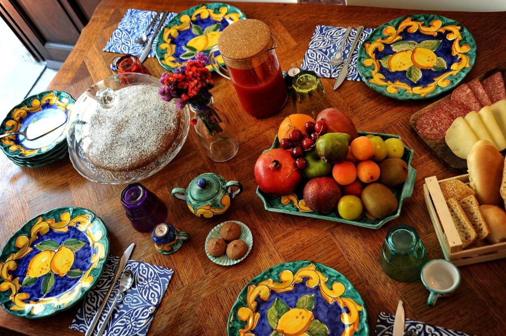 a wooden table with plates of fruit on it at Casa Castagna in Salerno