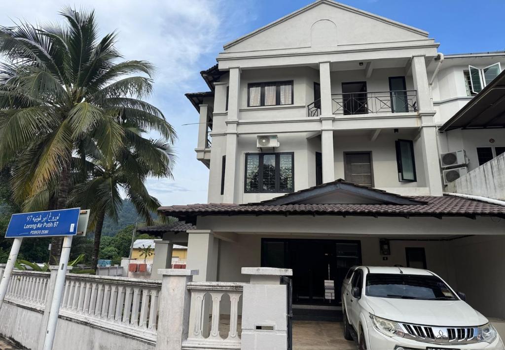 a white car parked in front of a house at Le Lodge Camp House in Kuantan