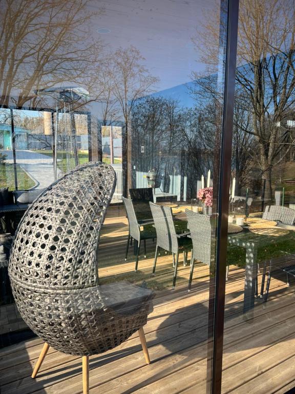 a metal chair sitting on top of a patio at Lake House in Telšiai