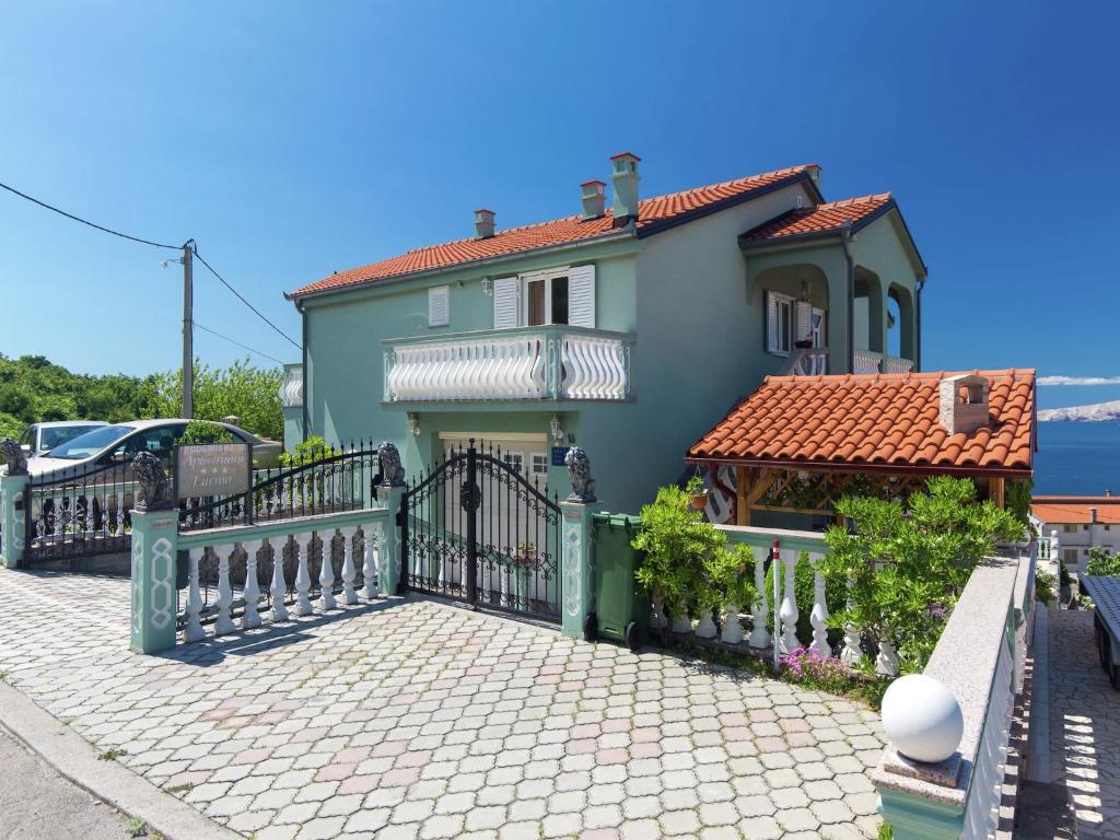 a house with a fence in front of it at Apartment in Senj near the Sea & Pool in Senj