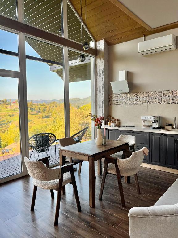 a kitchen and dining room with a table and chairs at Вирій in Slavske
