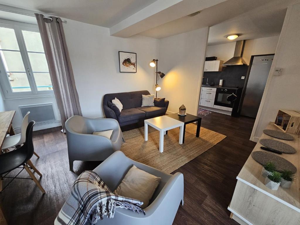 a living room with a couch and a table at Chez Sandrine in Angoulême
