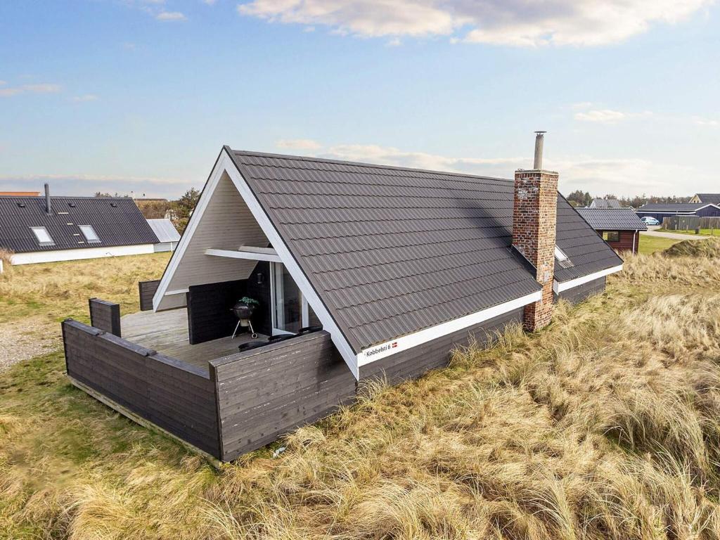 a small house on top of a field at 6 person holiday home in Thisted-By Traum in Torsted