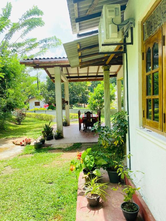 a front porch of a house with a patio at Hiriketiya Lima Homestay in Dickwella