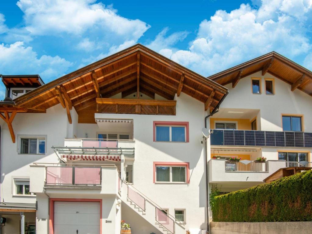 a white apartment building with solar panels on the roof at Apartment in Strengen near Ski Slopes in Strengen