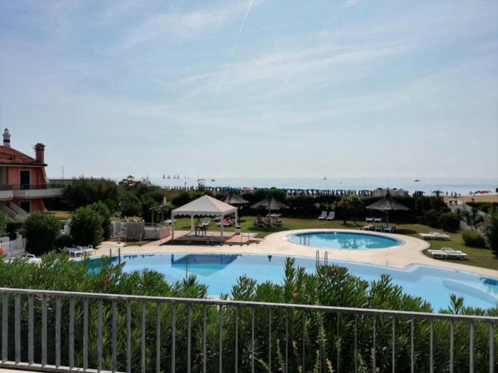 a view of a pool from a balcony of a resort at Residence Porto Sole in Cavallino-Treporti