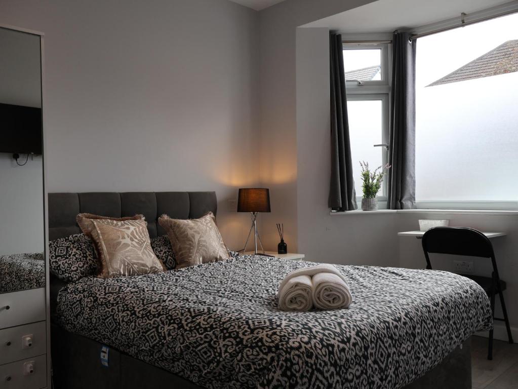 a bedroom with a bed with a pillow on it at Walton Suites in Watford