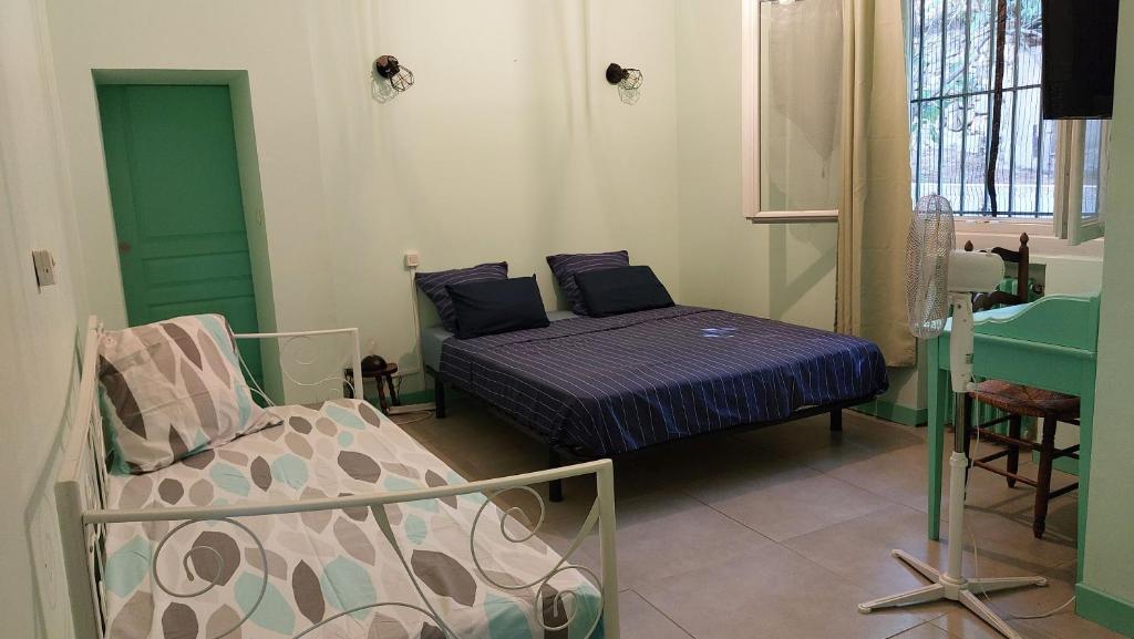 a bedroom with a bed and a chair in it at chambre dans villa in Marseille