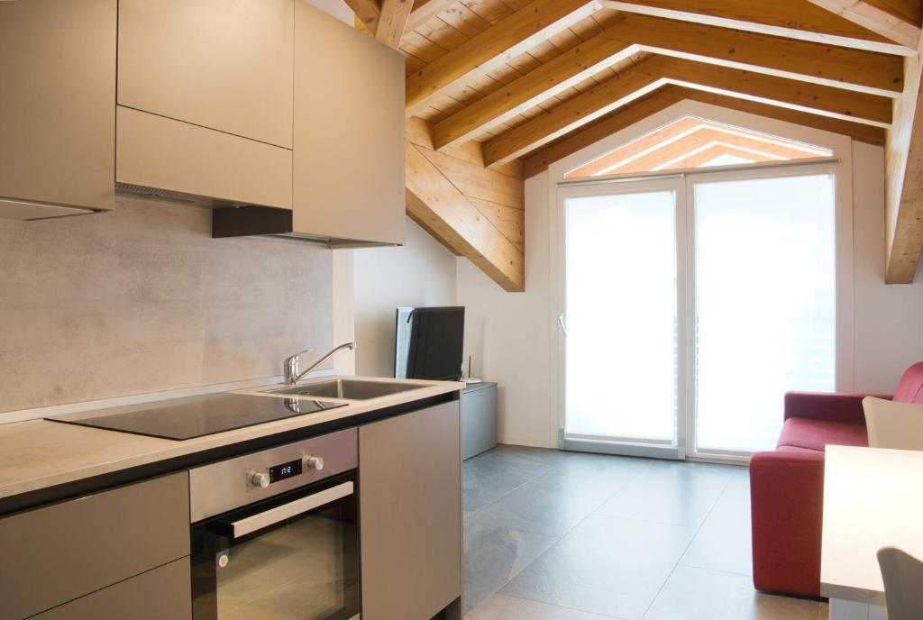 a kitchen with a sink and a large window at Residence La Corte di San Rocco in Cremeno