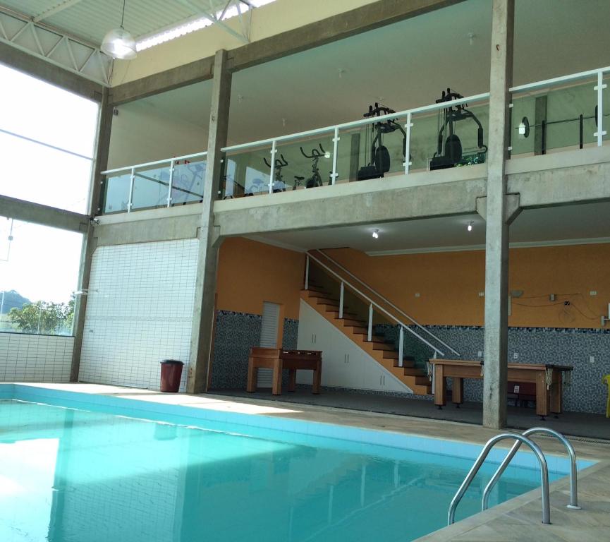 a building with a swimming pool and a balcony at Hotel Restaurante Boitupesca in Boituva