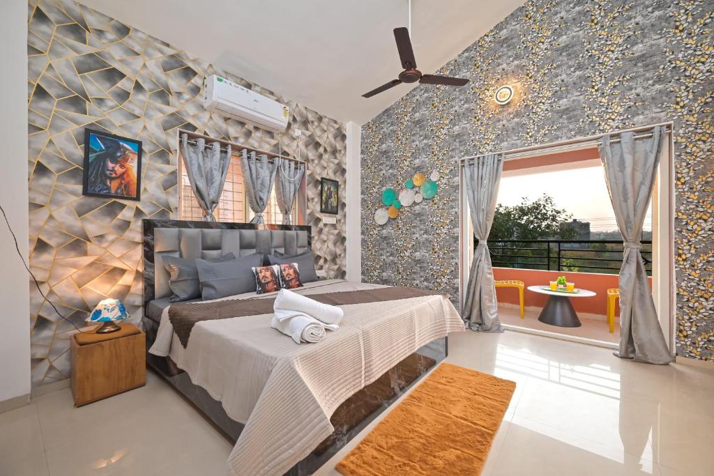 a bedroom with a bed and a ceiling fan at ll EMPYREAN STAY ll LUCIFER VILLA ll 2BHK ll AC ll PRIVATE POOL ll WIFI ll COUPLE FRIENDLY in Malavli