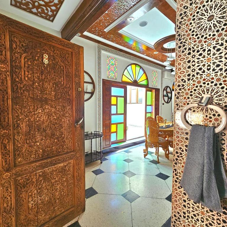 a room with a large wooden cabinet and a dining room at Fassia in Fez