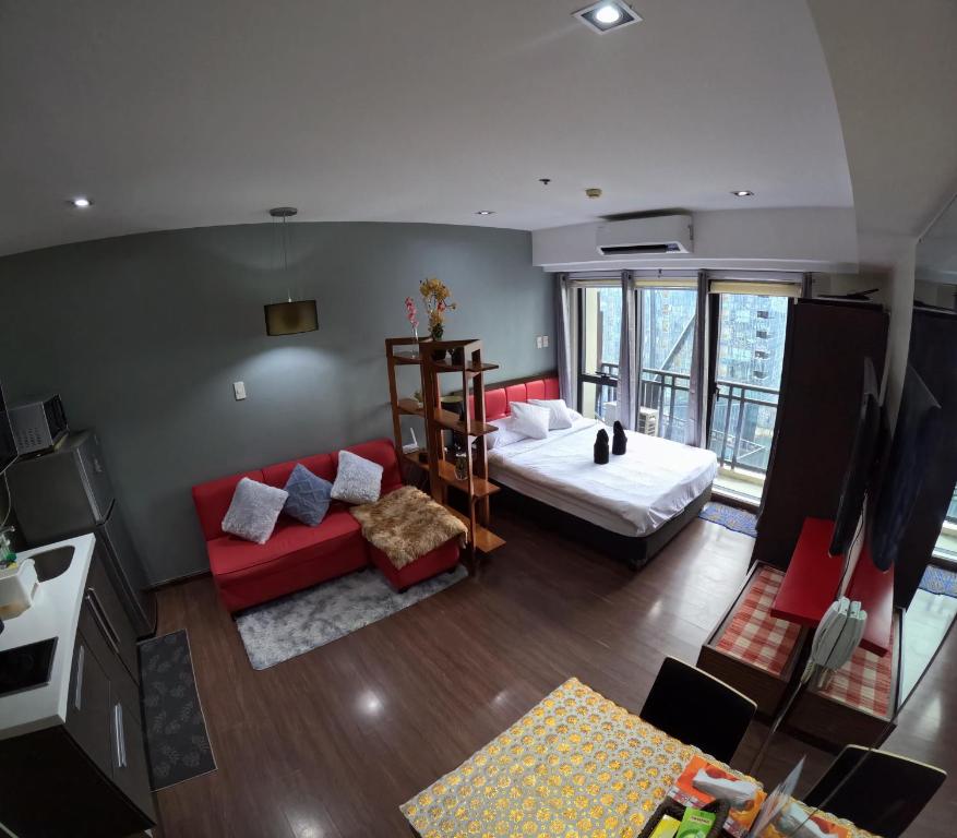 a living room with a bed and a couch at 56th Floor - Makati View - Knightsbridge Residences in Manila