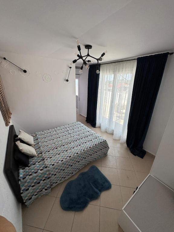 a bedroom with a bed and a window at Relax INN Sea and Olympus View in Nea Kallikrateia